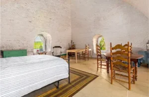 A cozy bedroom inside the Rose Island Lighthouse in Newport, RI, showcasing unique accommodation options and things to do in Newport RI.