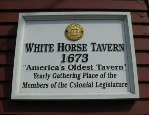 Close-up of the historical White Horse Tavern sign in Newport RI, proclaiming it as 'America's Oldest Tavern' since 1673.