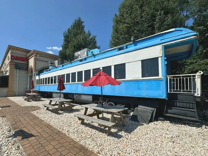Blue comet train car diner with outdoor seating, a unique New Jersey activity.