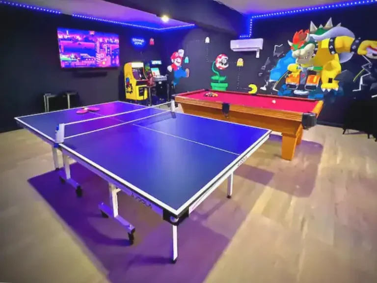 Colorful game room with ping pong and arcade games in a rental with indoor pool in Long Pond, PA.