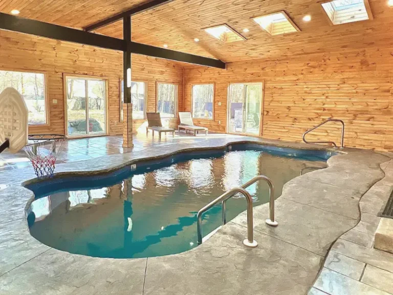 Rustic indoor pool with wooden walls in Long Pond, PA.