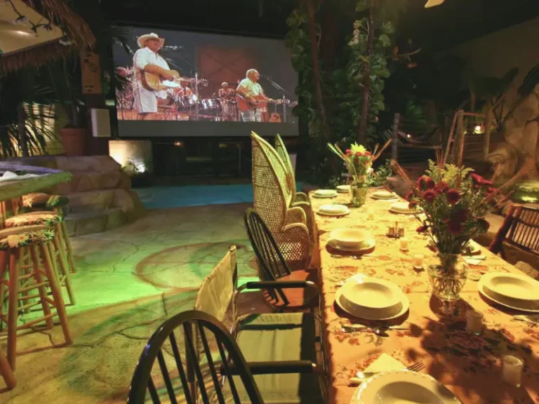 Poolside dining setup with a tropical backdrop in Media, PA Airbnb.