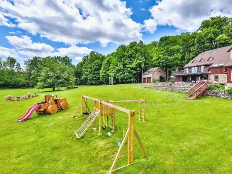 Wooden backyard playset with a slide in Windham, NY