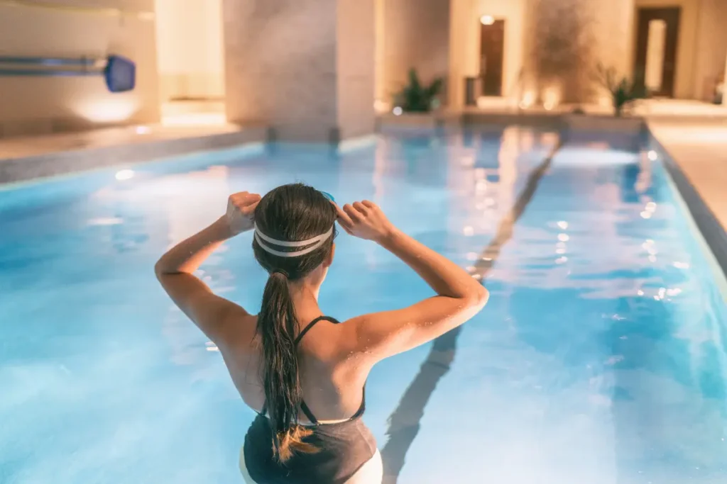 A woman ready to swim laps in an indoor pool