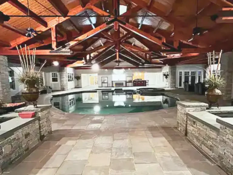 Indoor pool with warm lighting and vaulted ceilings in Salem, CT.