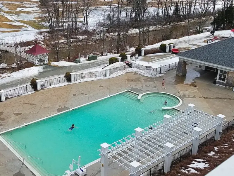 Heated outdoor pool at Omni Mount Washington with mountain views.