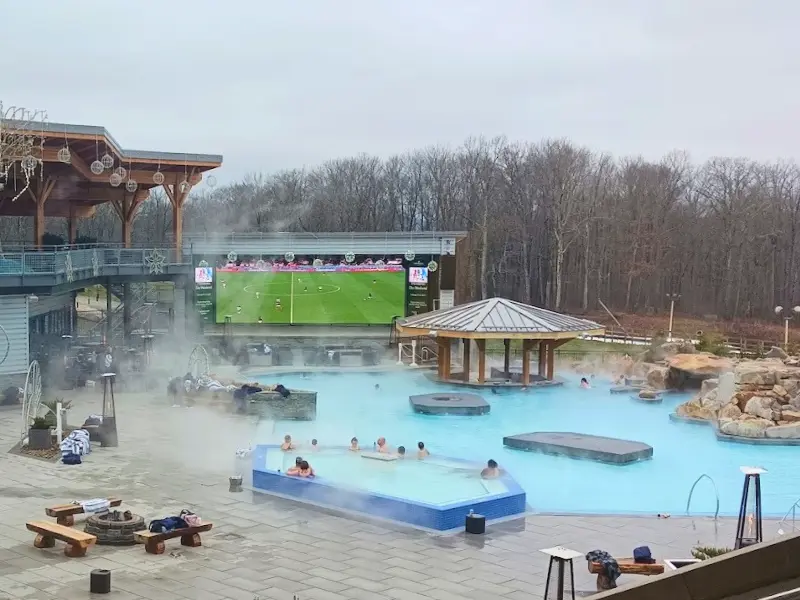 Steaming outdoor pool at Nemacolin in winter with guests enjoying.