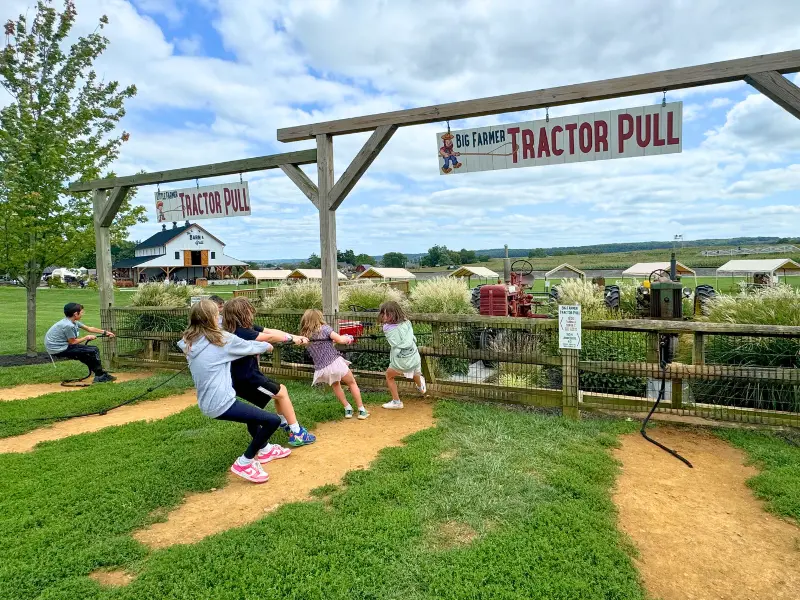 Kids doing a tractor pull game at Cherry Crest Adventure Farm in Lancaster.