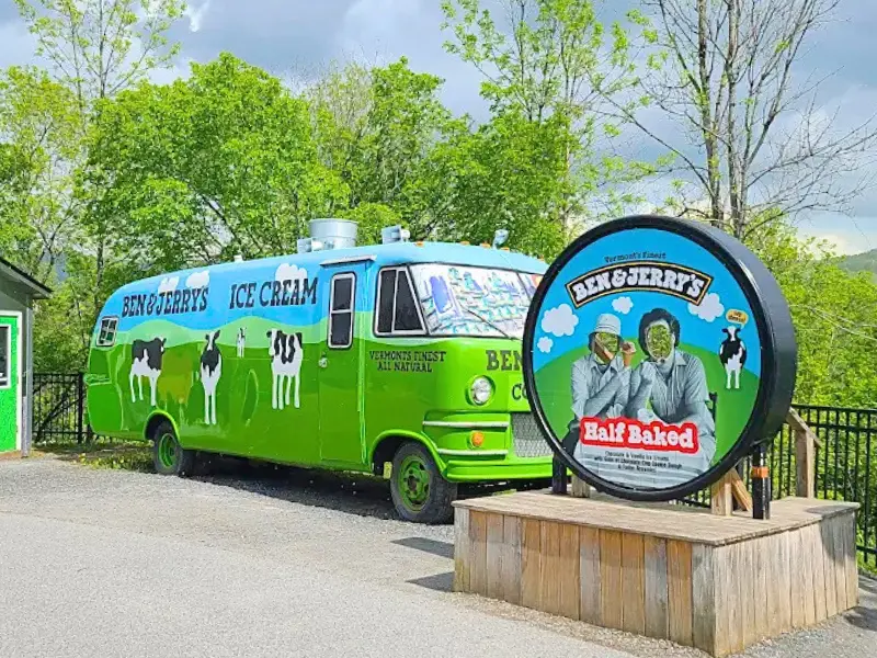 Ben & Jerry’s ice cream truck and Half Baked sign outside factory.