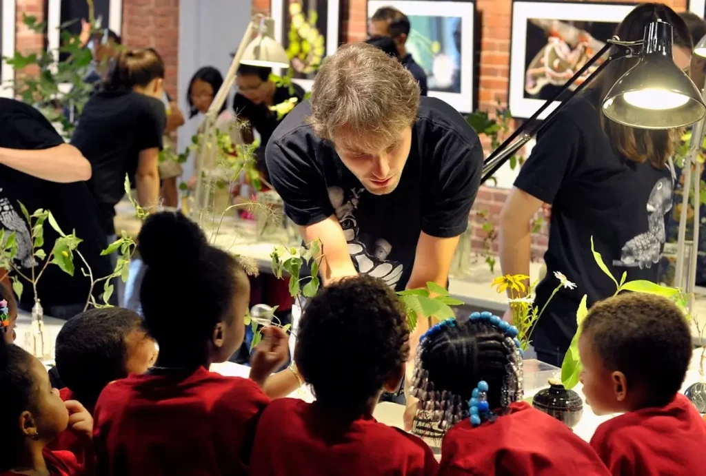 A teacher at The Caterpillar Lab teaching children about caterpillars
