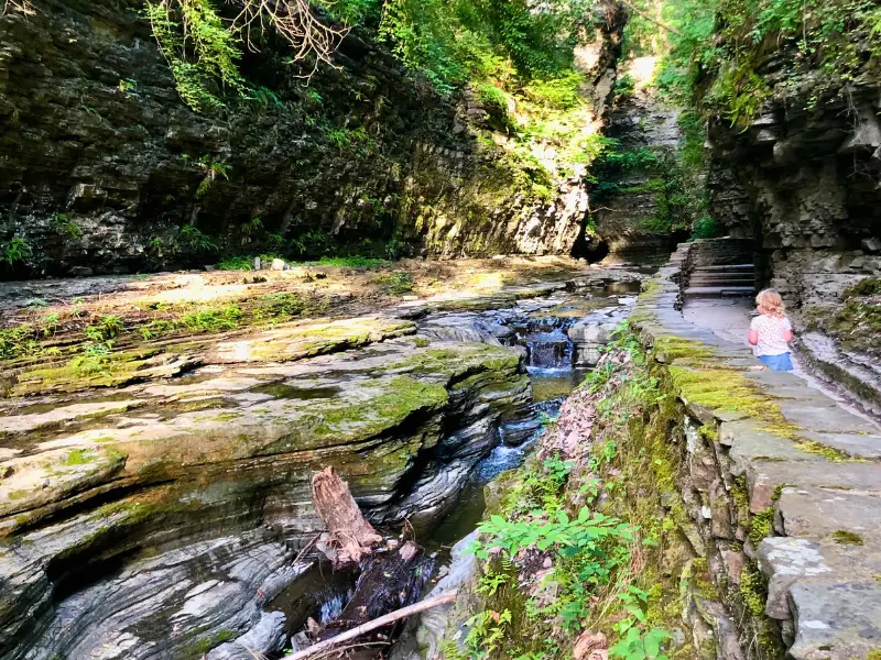 Child exploring Watkins Glen State Park trail in Upstate New York.