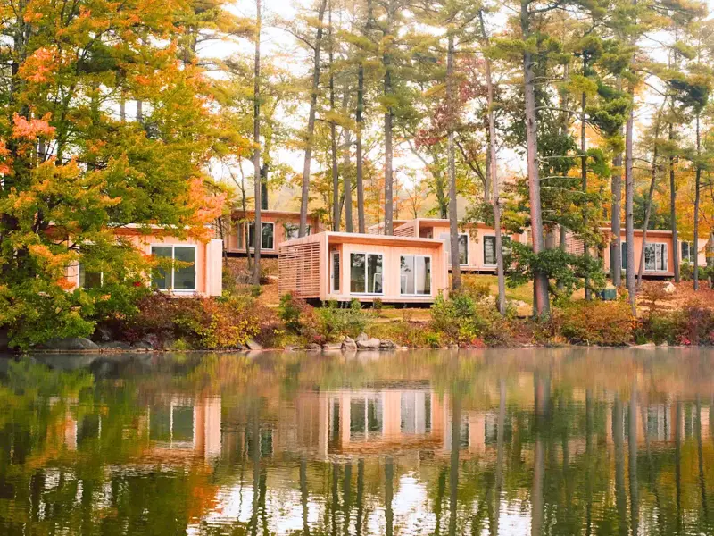 Modern lakeside cabins at Prospect Berkshires in fall foliage.