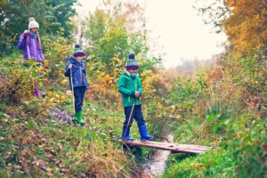 Family hiking a trail during fall foliage in the Northeast.