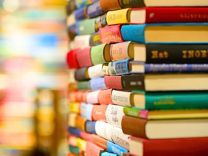 Stack of colorful hardcover books in a bookstore