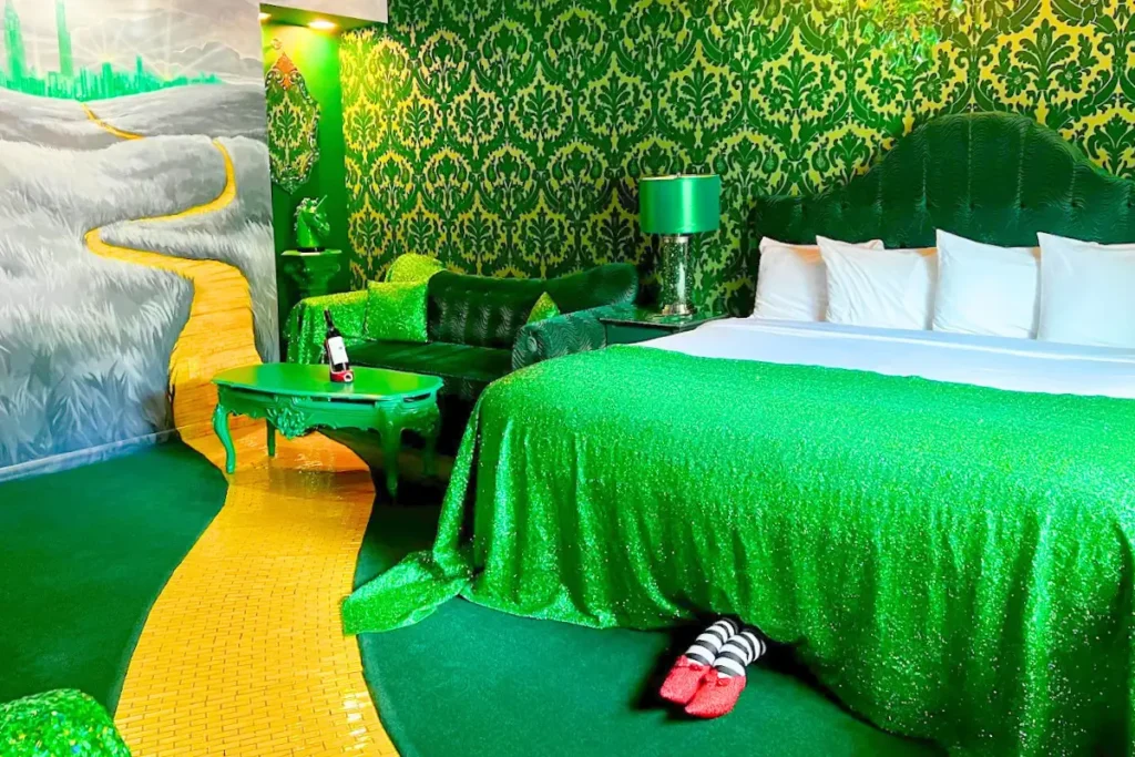 Emerald-green Wizard of Oz themed room with sparkling yellow brick road.