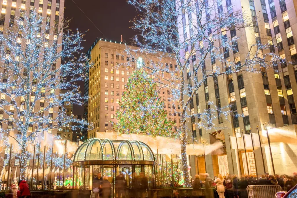 Rockefeller Center Christmas Tree lit up at night surrounded by sparkling lights, a must for Things to do in Manhattan in December