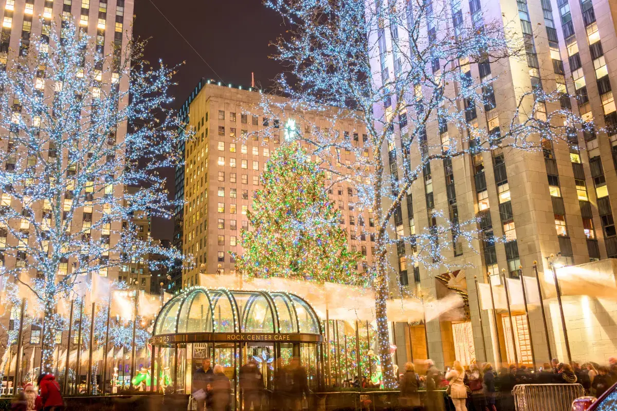 Rockefeller Center Christmas Tree lit up at night surrounded by sparkling lights, a must for Things to do in Manhattan in December