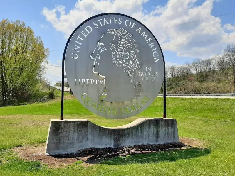 Giant Quarter roadside landmark sculpture in Everett Pennsylvania, a quirky roadside attraction and free photo stop