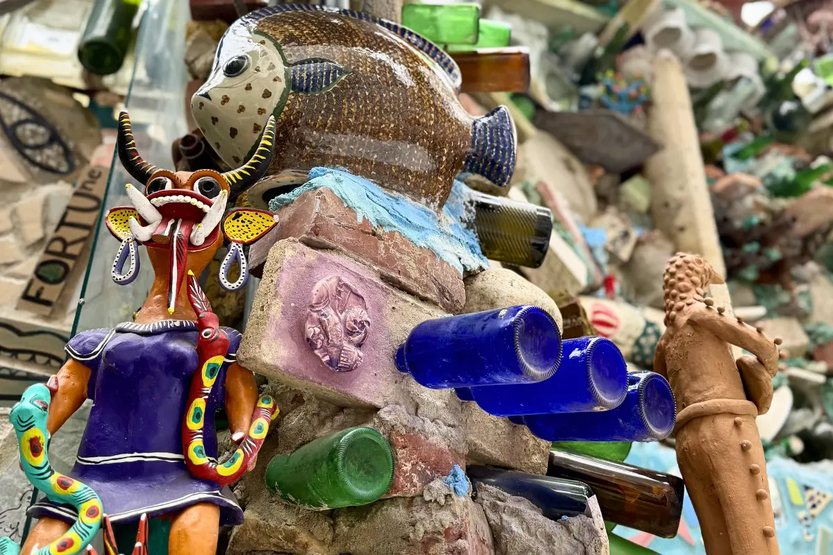 Close-up of mosaic figures and glass bottles at Philadelphia’s Magic Gardens