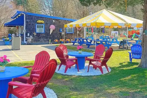 Outdoor seating and play area at Captain Bonney’s Ice Cream in Rochester with colorful chairs and family space