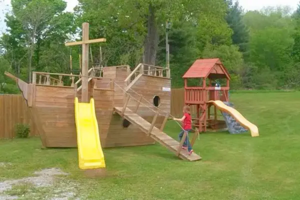 Wooden pirate ship playground at Krispy Cones Ice Cream in Lanesborough, one of the restaurants with playgrounds in Massachusetts