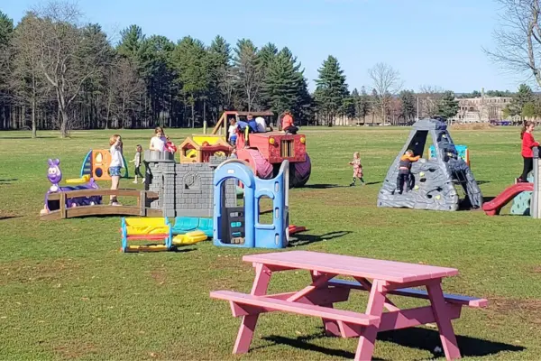 Open field with playground toys and seating at Cindy’s Drive-In in Granby, a classic restaurants with playgrounds in Massachusetts